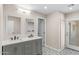 Bathroom featuring a double sink vanity, decorative floors, and modern fixtures at 1911 E Lawrence Rd, Phoenix, AZ 85016