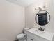 Bathroom featuring toilet, vanity with white sink, mirror, and accent lighting at 1911 E Lawrence Rd, Phoenix, AZ 85016