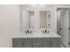 Bathroom featuring a double sink vanity, decorative floors, and modern fixtures at 1911 E Lawrence Rd, Phoenix, AZ 85016