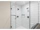 Sleek bathroom shower with subway tile, glass enclosure, and dual shower heads at 1911 E Lawrence Rd, Phoenix, AZ 85016