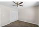 Neutral bedroom featuring a ceiling fan, carpet flooring, and a large closet for storage at 1911 E Lawrence Rd, Phoenix, AZ 85016
