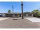 Charming home boasts desert landscaping, complemented by palm trees and a basketball court at 1911 E Lawrence Rd, Phoenix, AZ 85016