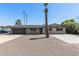 Charming home boasts desert landscaping, complemented by palm trees and a basketball court at 1911 E Lawrence Rd, Phoenix, AZ 85016