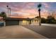 Charming home boasts desert landscaping, complemented by palm trees and a newly sealed driveway at 1911 E Lawrence Rd, Phoenix, AZ 85016