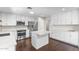 Modern kitchen featuring stainless steel appliances, white cabinetry, a kitchen island, and marble countertops at 1911 E Lawrence Rd, Phoenix, AZ 85016