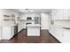 Well-lit kitchen boasts white cabinetry, a center island with marble countertops, and stainless steel appliances at 1911 E Lawrence Rd, Phoenix, AZ 85016