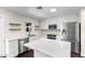 Modern kitchen featuring white cabinets, stainless steel appliances, and a marble countertop island at 1911 E Lawrence Rd, Phoenix, AZ 85016