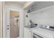 Modern laundry room equipped with new appliances and shelving for storage at 1911 E Lawrence Rd, Phoenix, AZ 85016