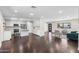 Open concept living room and kitchen with stainless steel appliances and dark wood flooring throughout at 1911 E Lawrence Rd, Phoenix, AZ 85016