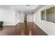 Bright and airy living room featuring hardwood floors and neutral paint, offering a versatile living space at 1911 E Lawrence Rd, Phoenix, AZ 85016