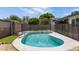 Backyard boasts a sparkling pool with a safety fence, surrounded by lush landscaping at 1911 E Lawrence Rd, Phoenix, AZ 85016