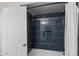 Bathroom featuring tiled shower with black fixtures and a built-in shower niche at 1911 E Lawrence Rd, Phoenix, AZ 85016