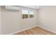 An empty room with light walls, new flooring, ceiling mounted mini-split AC, and a new window at 1911 E Lawrence Rd, Phoenix, AZ 85016