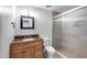 Charming bathroom with wood vanity, bronze fixtures, and framed shower at 1930 W Voltaire Ave, Phoenix, AZ 85029