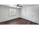 Bedroom with wood-look vinyl floors, shuttered window, and floating shelves at 1930 W Voltaire Ave, Phoenix, AZ 85029
