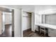 Bright bedroom featuring wood floors, a closet, and a vanity with a large mirror at 1930 W Voltaire Ave, Phoenix, AZ 85029