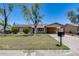 Charming single-story home with a well-manicured lawn and mature landscaping at 1930 W Voltaire Ave, Phoenix, AZ 85029
