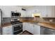 Updated kitchen featuring stainless steel appliances, granite countertops, and modern backsplash at 1930 W Voltaire Ave, Phoenix, AZ 85029