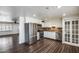 Modern kitchen with white cabinets, stainless steel appliances, and hardwood floors overlooking the living area at 1930 W Voltaire Ave, Phoenix, AZ 85029