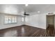 Bright and airy living room featuring hardwood floors, white walls, and a view of the front yard at 1930 W Voltaire Ave, Phoenix, AZ 85029