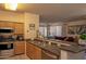 Open kitchen with stainless appliances, wood cabinetry, and a view of the connected living area, perfect for entertaining at 19777 N 76Th St # 2142, Scottsdale, AZ 85255