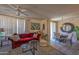 Bright living room featuring a comfortable red sofa, neutral tones, stylish decor, and an inviting atmosphere at 19777 N 76Th St # 2142, Scottsdale, AZ 85255
