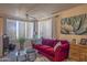 Inviting living room showcasing a red sofa, modern decor, and plenty of natural light, creating a cozy ambiance at 19777 N 76Th St # 2142, Scottsdale, AZ 85255
