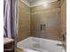Tiled bathroom featuring a soaking tub and shower with modern fixtures at 2006 W Gold Dust Ave, Queen Creek, AZ 85144