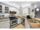 Updated kitchen with white cabinetry, stainless steel appliances, and tile backsplash at 2006 W Gold Dust Ave, Queen Creek, AZ 85144