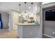 Open kitchen design with granite countertops, stainless steel appliances, and modern pendant lighting at 2006 W Gold Dust Ave, Queen Creek, AZ 85144