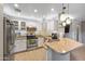 Bright kitchen featuring white cabinets, granite countertops, stainless steel appliances, and breakfast bar at 2006 W Gold Dust Ave, Queen Creek, AZ 85144