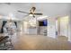Bright living space with tile floors, ceiling fan, open layout connecting to the kitchen and dining area at 2006 W Gold Dust Ave, Queen Creek, AZ 85144