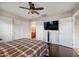 Main bedroom with hardwood floors, a ceiling fan, and an attached bathroom at 2006 W Gold Dust Ave, Queen Creek, AZ 85144