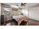 Cozy bedroom featuring hardwood floors, natural light, and a ceiling fan at 2006 W Gold Dust Ave, Queen Creek, AZ 85144