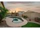 Private backyard pool area with desert landscaping, artificial turf, and a charming pergola at 2006 W Gold Dust Ave, Queen Creek, AZ 85144