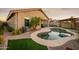 Backyard pool and patio with lush landscaping, offering outdoor relaxation and enjoyment at 2006 W Gold Dust Ave, Queen Creek, AZ 85144
