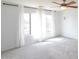 Bright bedroom with neutral paint and plush carpeting has natural light provided by large windows at 20258 S 196Th St, Queen Creek, AZ 85142