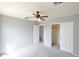 Spacious bedroom with a ceiling fan, plush carpeting, and a closet with sliding doors at 20258 S 196Th St, Queen Creek, AZ 85142