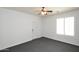 Bright bedroom with dark plush carpeting has a window with shutters and a door to the exterior at 20258 S 196Th St, Queen Creek, AZ 85142