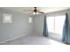 Neutral-toned bedroom with ceiling fan, and plush carpeting has windows and shutters for climate control at 20258 S 196Th St, Queen Creek, AZ 85142