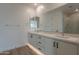 Bright bathroom with dual sinks, vanity, and a large mirror at 21411 W Meadowbrook Ave, Buckeye, AZ 85396