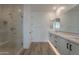Bathroom featuring a glass-enclosed shower, double sinks, and stylish fixtures at 21411 W Meadowbrook Ave, Buckeye, AZ 85396