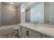 This bright bathroom has a shower and tub combo and a neutral color palette at 21411 W Meadowbrook Ave, Buckeye, AZ 85396