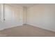 This cozy bedroom features neutral carpeting and a spacious closet for optimal storage at 21411 W Meadowbrook Ave, Buckeye, AZ 85396