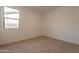 This bedroom offers neutral carpeting, bright natural light and a spacious feel at 21411 W Meadowbrook Ave, Buckeye, AZ 85396