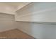 Walk-in closet with shelving and carpeted floor at 21411 W Meadowbrook Ave, Buckeye, AZ 85396