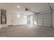This spacious garage features high ceilings, overhead lighting and room for two cars at 21411 W Meadowbrook Ave, Buckeye, AZ 85396