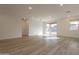Unfurnished living space with wood-look tile flooring, recessed lighting, and large sliding glass doors at 21411 W Meadowbrook Ave, Buckeye, AZ 85396