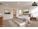 Staged bedroom showcasing neutral decor and a glimpse into the attached bathroom at 21411 W Meadowbrook Ave, Buckeye, AZ 85396