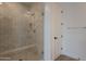 Close up of stylish tiled shower with glass door and modern fixtures at 21411 W Meadowbrook Ave, Buckeye, AZ 85396